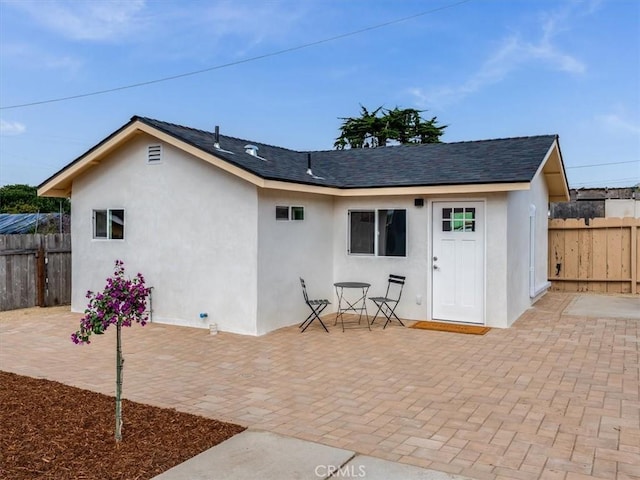 1912 8th St, Los Osos, CA 93402 - back of house featuring a patio, stucco siding, and a shingled roof