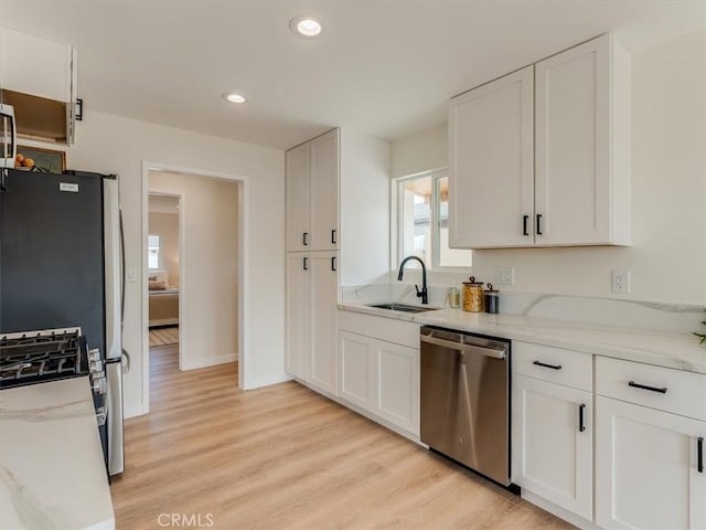 1912 8th St, Los Osos, CA 93402 - kitchen featuring a sink, light wood-style floors, white cabinets, and stainless steel dishwasher