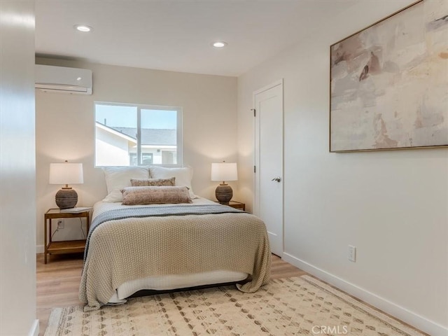 1912 8th St, Los Osos, CA 93402 - bedroom featuring recessed lighting, baseboards, a wall unit AC, and light wood-type flooring
