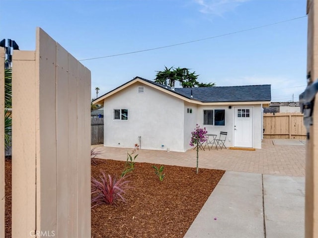 1912 8th St, Los Osos, CA 93402 - exterior space featuring a patio, fence, roof with shingles, and stucco siding