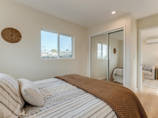 1912 8th St, Los Osos, CA 93402 - bedroom featuring an AC wall unit, recessed lighting, baseboards, wood finished floors, and a closet