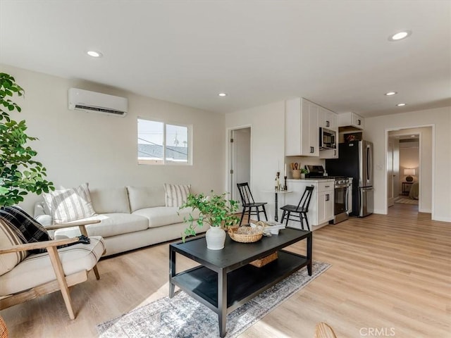 1912 8th St, Los Osos, CA 93402 - living area featuring light wood-type flooring, a wall mounted air conditioner, baseboards, and recessed lighting