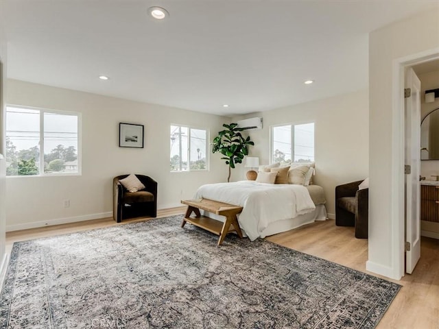 1912 8th St, Los Osos, CA 93402 - bedroom with an AC wall unit, light wood finished floors, baseboards, and multiple windows