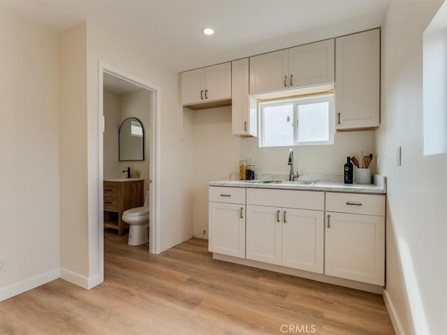1912 8th St, Los Osos, CA 93402 - kitchen featuring light countertops, white cabinetry, light wood-style flooring, and recessed lighting