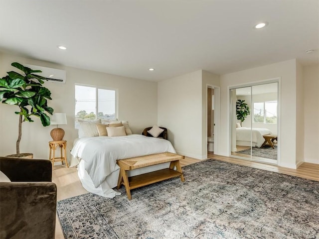 1912 8th St, Los Osos, CA 93402 - bedroom with a closet, light wood-style floors, baseboards, recessed lighting, and a wall unit AC