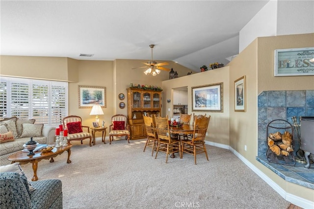 dining area featuring lofted ceiling, baseboards, carpet floors, visible vents, and a ceiling fan