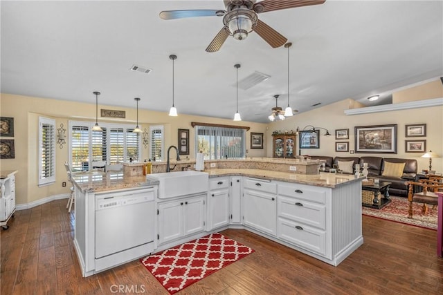 kitchen featuring vaulted ceiling, a sink, dishwasher, open floor plan, and ceiling fan