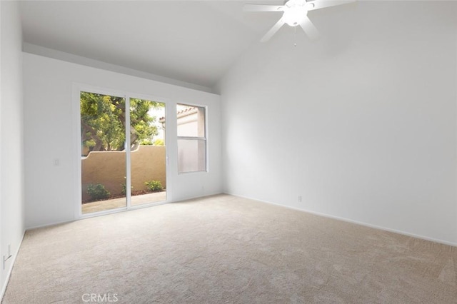 empty room with a ceiling fan, lofted ceiling, and carpet