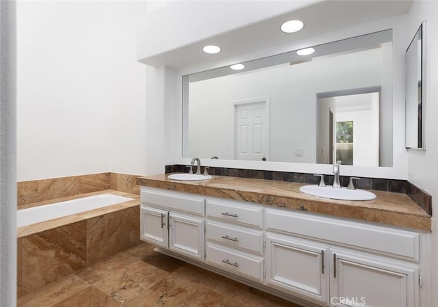 full bathroom featuring a bath, double vanity, a sink, and recessed lighting