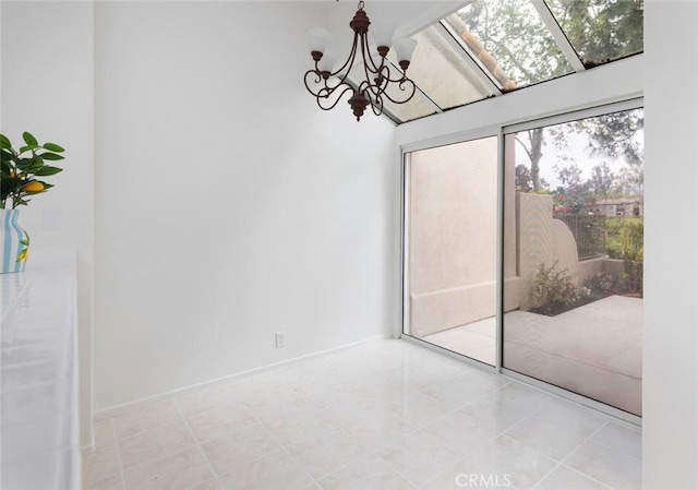 empty room with a wealth of natural light and a chandelier