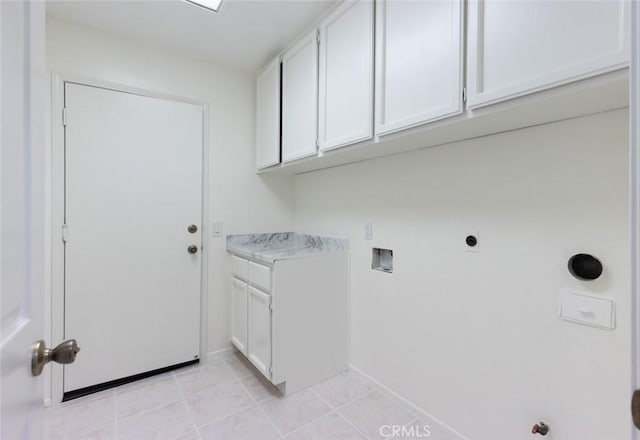 clothes washing area with baseboards, hookup for a washing machine, cabinet space, and light tile patterned flooring