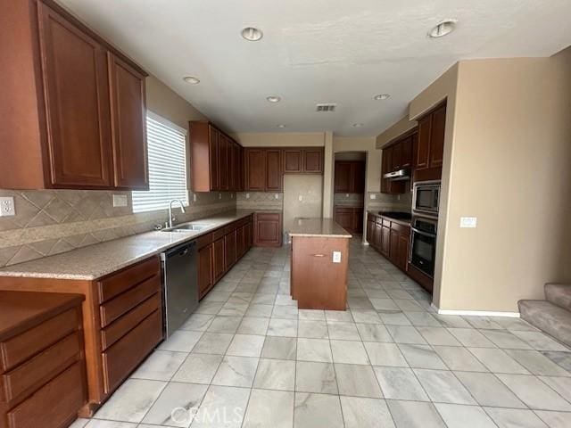 2420 Lenai Cir, Corona, CA 92879 - kitchen featuring tasteful backsplash, a sink, stainless steel appliances, light countertops, and under cabinet range hood