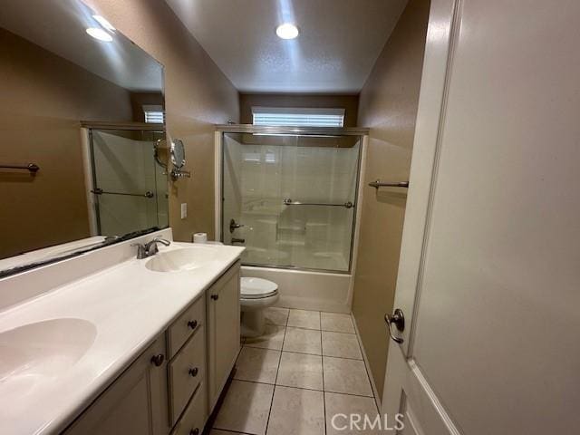 2420 Lenai Cir, Corona, CA 92879 - bathroom with a sink, tile patterned floors, toilet, double vanity, and enclosed tub / shower combo