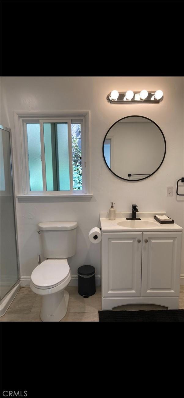 610 E Fairview, Inglewood, CA 90302 - bathroom featuring a shower stall, baseboards, toilet, and vanity