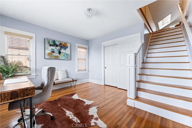 office featuring baseboards, wood finished floors, and plenty of natural light