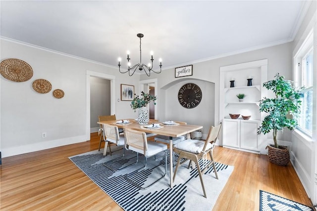 dining area with a chandelier, light wood-type flooring, and plenty of natural light