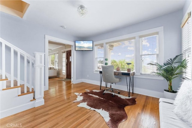 office area with baseboards, a wealth of natural light, and wood finished floors
