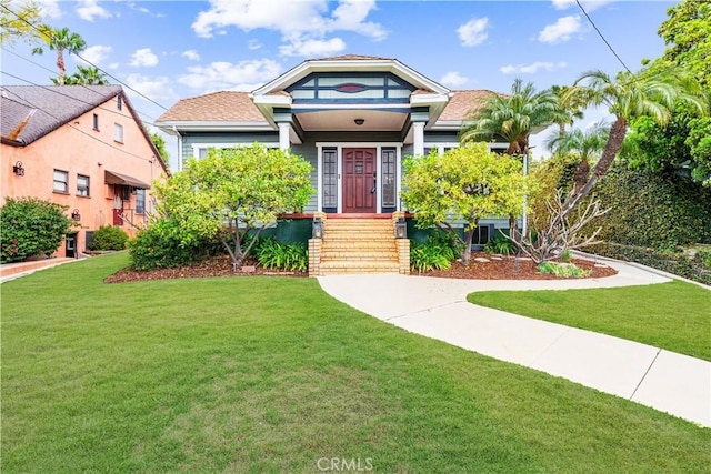 bungalow-style home featuring a front yard