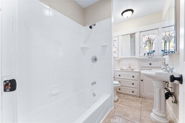 full bathroom featuring tile patterned flooring, toilet, and  shower combination