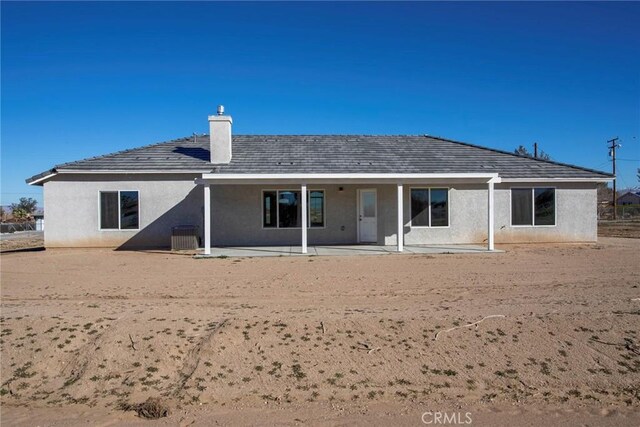 17796 Valencia St, Hesperia, CA 92345 - rear view of house featuring a chimney, a patio area, and stucco siding