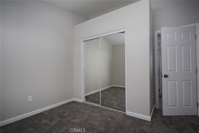17796 Valencia St, Hesperia, CA 92345 - unfurnished bedroom featuring dark carpet, a closet, and baseboards