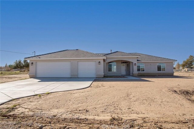 17796 Valencia St, Hesperia, CA 92345 - single story home with a garage, concrete driveway, a tile roof, and stucco siding