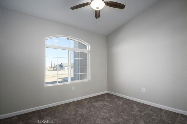 17796 Valencia St, Hesperia, CA 92345 - spare room with dark colored carpet, ceiling fan, baseboards, and vaulted ceiling