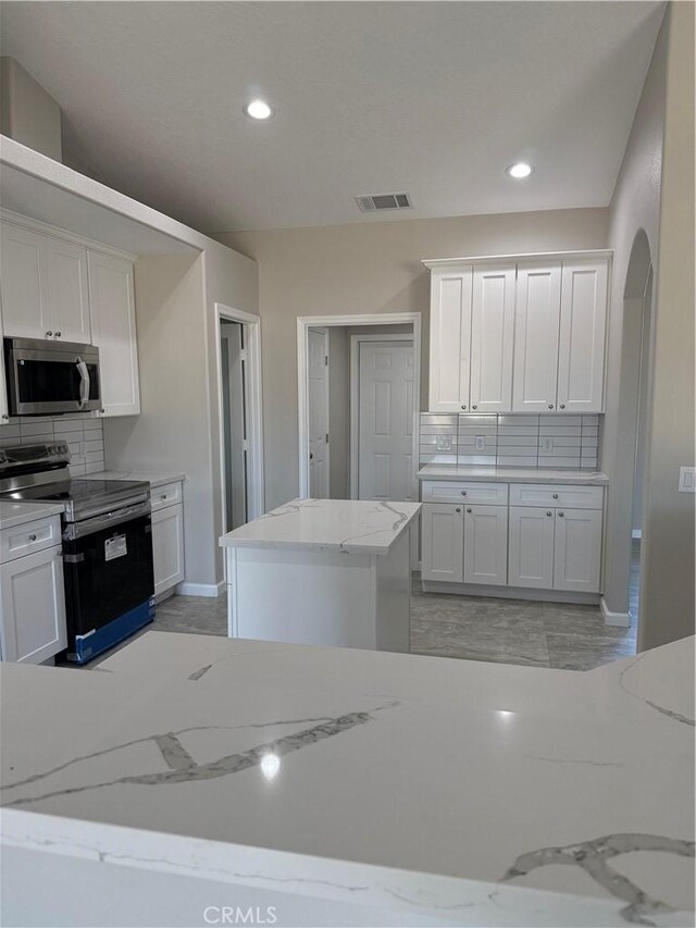 17796 Valencia St, Hesperia, CA 92345 - kitchen with appliances with stainless steel finishes, backsplash, white cabinets, baseboards, and recessed lighting