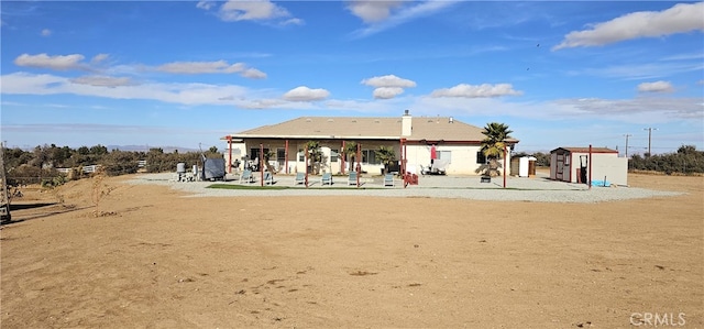 7445 Cedar St, Phelan, CA 92371 - exterior space with a storage unit, a patio, and an outbuilding