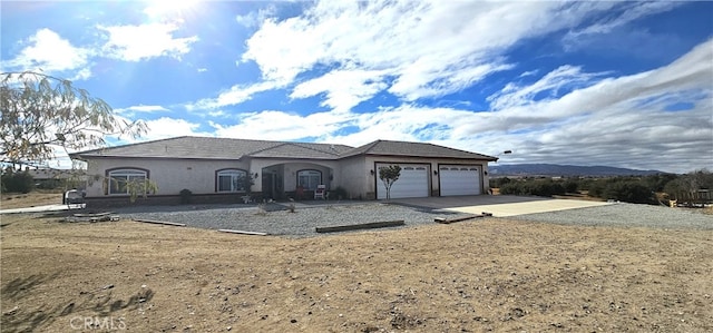7445 Cedar St, Phelan, CA 92371 - view of front of house featuring a garage, stucco siding, and concrete driveway