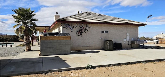 7445 Cedar St, Phelan, CA 92371 - view of side of home with a chimney and stucco siding