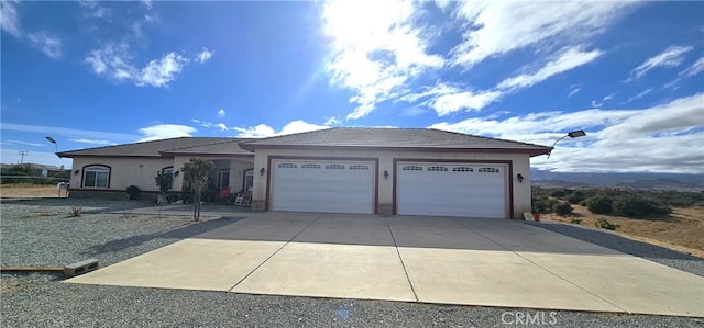 7445 Cedar St, Phelan, CA 92371 - view of front of house featuring an attached garage, stucco siding, and driveway