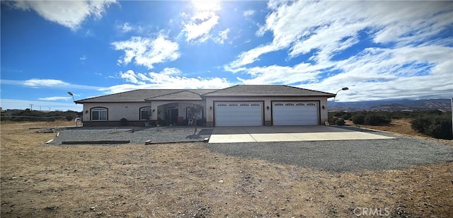 7445 Cedar St, Phelan, CA 92371 - view of front of house featuring a garage, stucco siding, and driveway