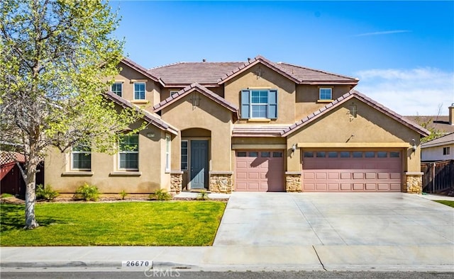 view of front of property with a tiled roof, stucco siding, fence, a front lawn, and driveway