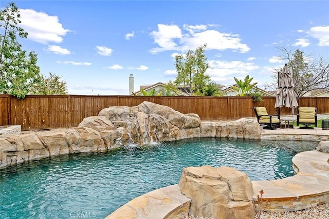 view of swimming pool featuring a fenced backyard and a fenced in pool