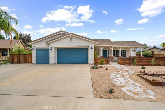 single story home with a garage, a porch, fence, and concrete driveway