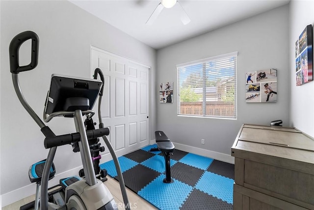 exercise area featuring baseboards and ceiling fan