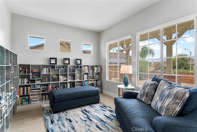 sitting room featuring a healthy amount of sunlight, baseboards, and wood finished floors