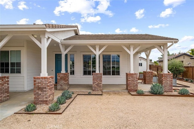 exterior space with covered porch and fence