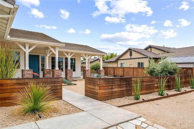 view of patio featuring a porch and fence