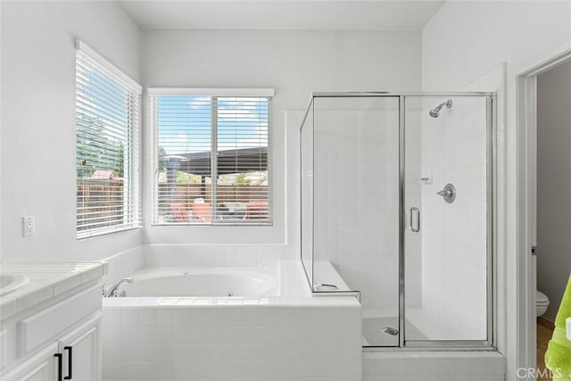 bathroom with a shower stall, plenty of natural light, and a garden tub