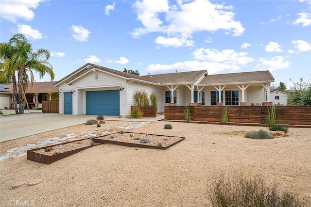 ranch-style home featuring a garage, fence, and concrete driveway