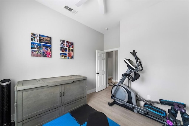 exercise room with light wood finished floors, ceiling fan, baseboards, and visible vents