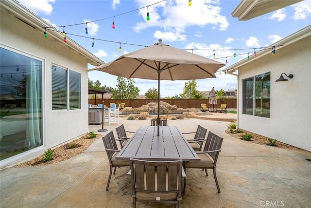 view of patio / terrace with outdoor dining space and fence