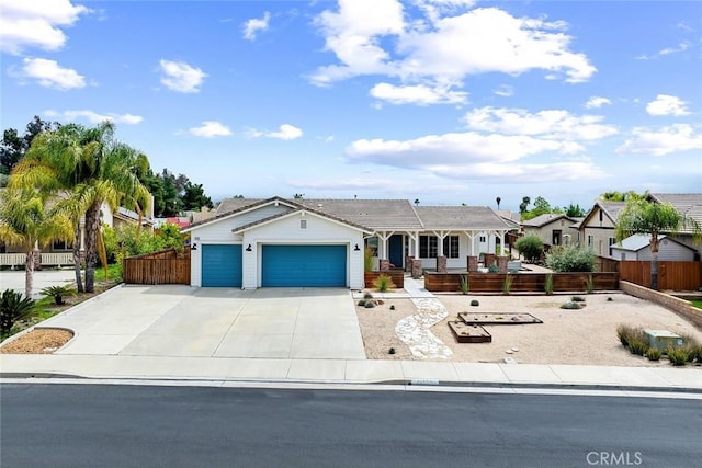 single story home featuring driveway, fence, a garage, and a porch