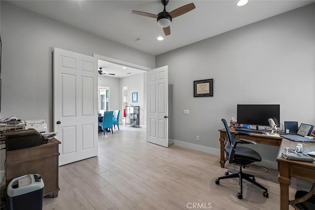 office space featuring recessed lighting, light wood-style flooring, baseboards, and a ceiling fan