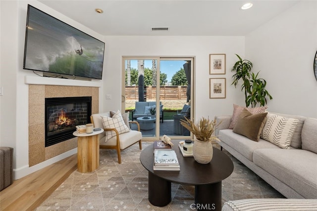 1517 Felspar St, San Diego, CA 92109 - living area with a tiled fireplace, wood finished floors, recessed lighting, and baseboards