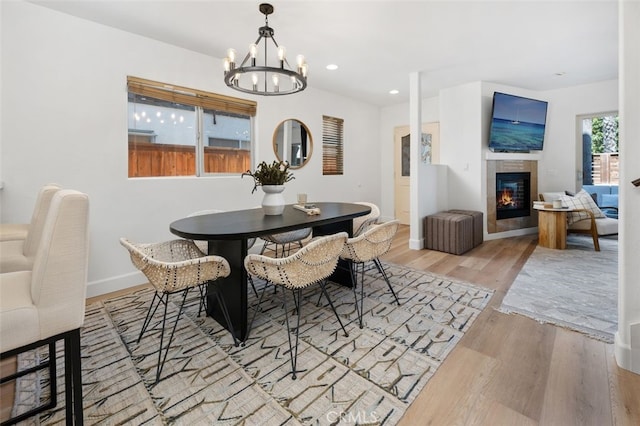 1517 Felspar St, San Diego, CA 92109 - dining space with wood finished floors, a chandelier, a tiled fireplace, recessed lighting, and baseboards
