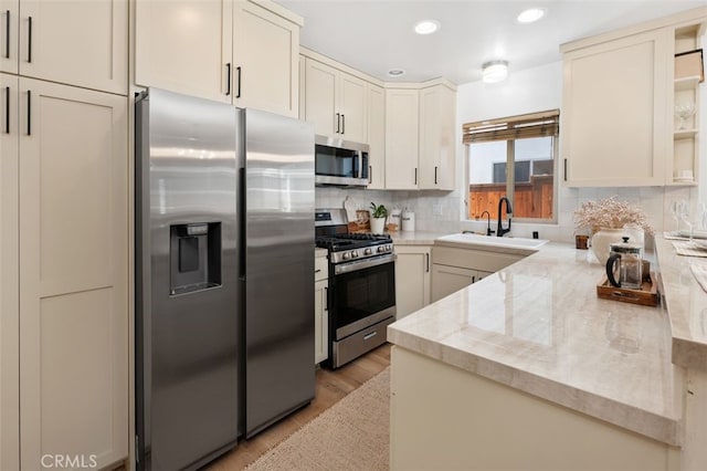1517 Felspar St, San Diego, CA 92109 - kitchen featuring appliances with stainless steel finishes, light wood-type flooring, a sink, recessed lighting, and decorative backsplash