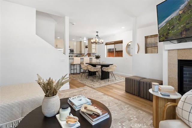 1517 Felspar St, San Diego, CA 92109 - living area featuring light wood-type flooring, a chandelier, a fireplace, and recessed lighting
